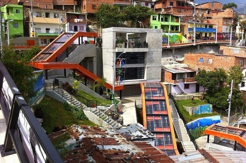 The orange outdoor escalators climbing the hillside of Comuna 13 in Medellin